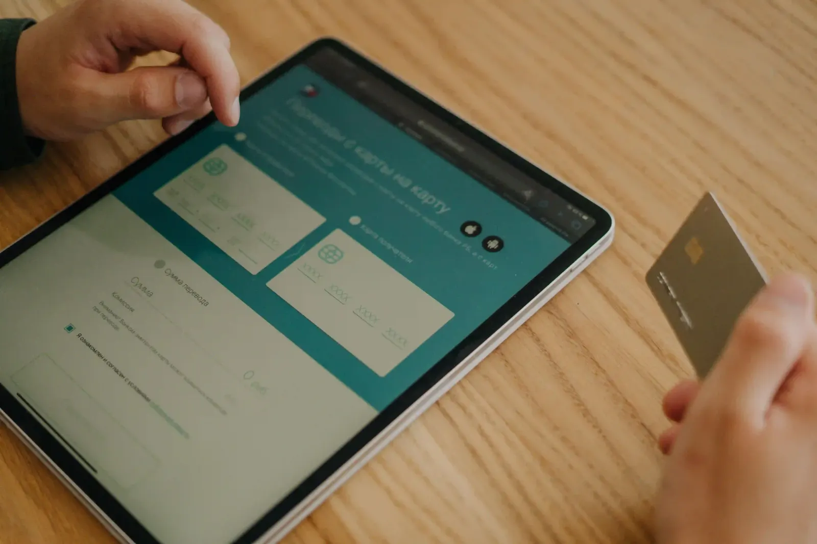 Person using a tablet to make an online card payment